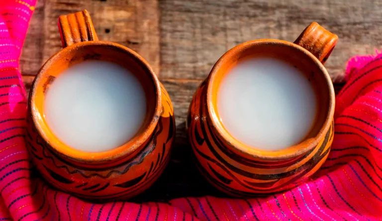 dos tazas de cerámica con pulque